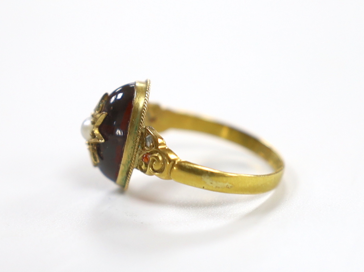 An Edwardian 18ct gold, cabochon garnet, split pearl and gem set ring, size N, gross weight 2.7 grams, with original box.